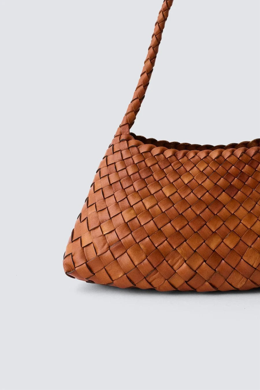 Brown woven handbag on a light gray background