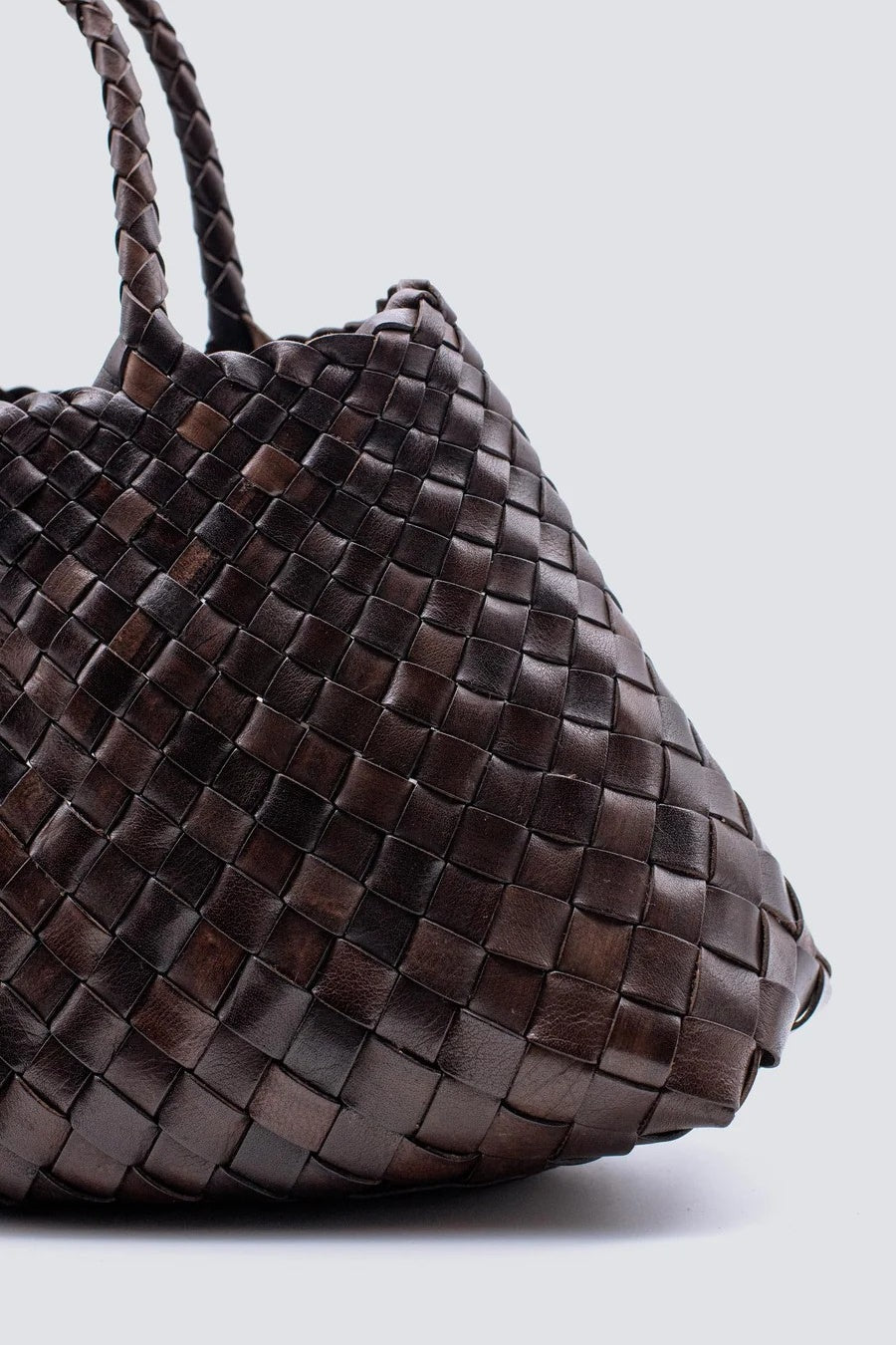 Close-up of a woven handbag with a white background