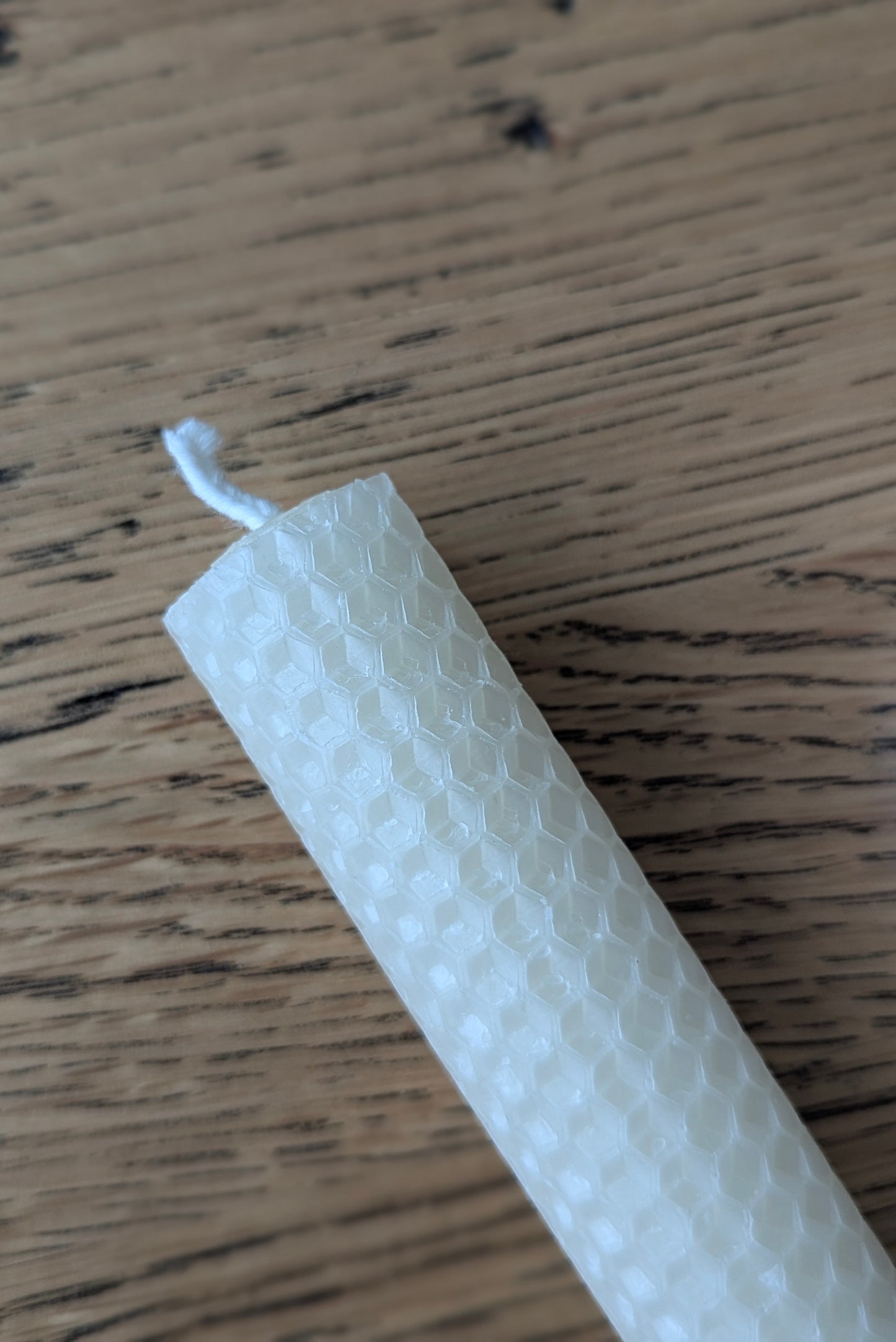 Beeswax candle on a wooden tsble