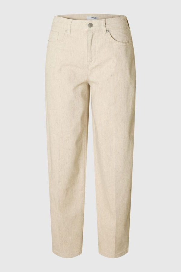A pair of beige, denim barrel jeans with a mid waist and zip-up fly.