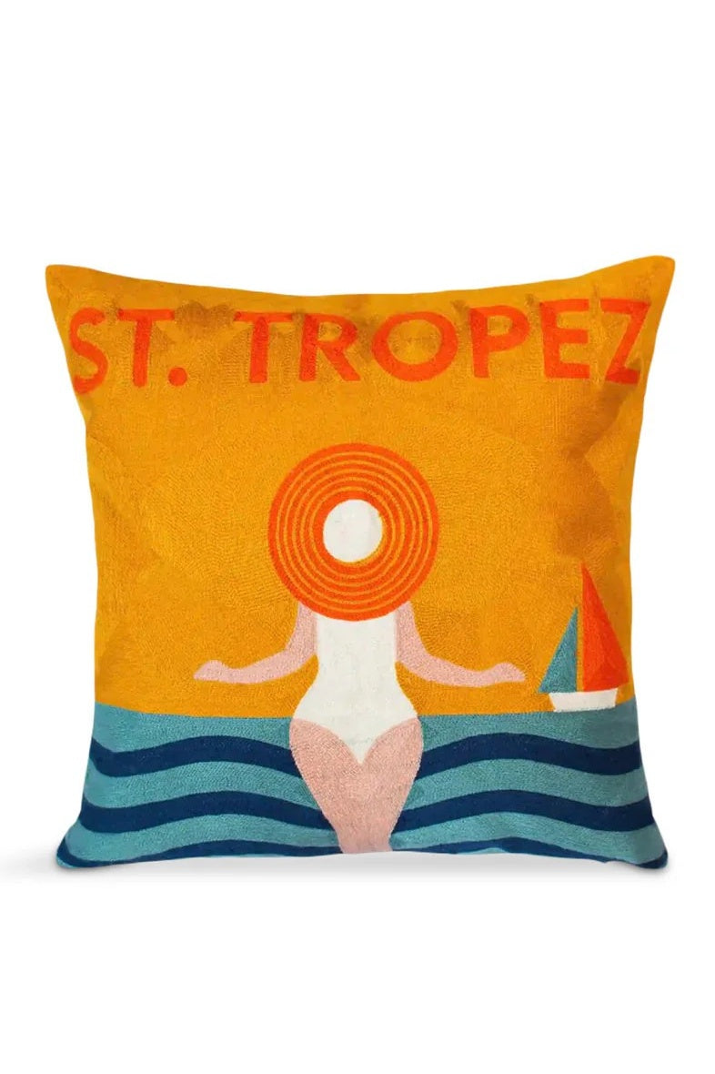 Decorative pillow with 'St. Tropez' text and beach scene design on an orange background
