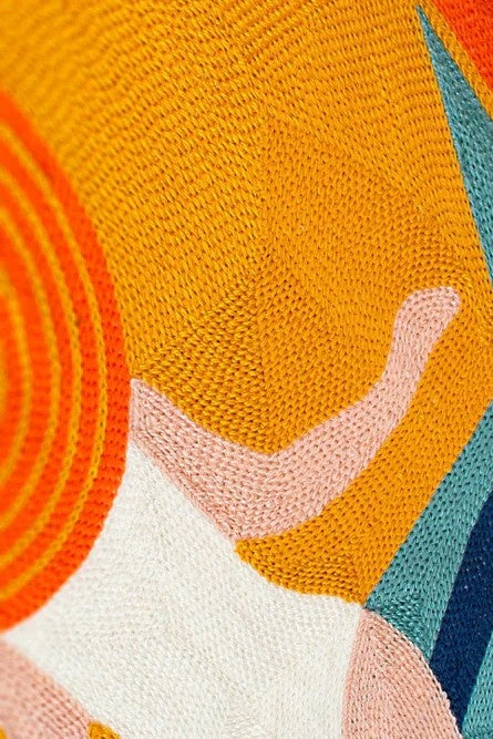 Close-up of a textured fabric with colorful abstract patterns