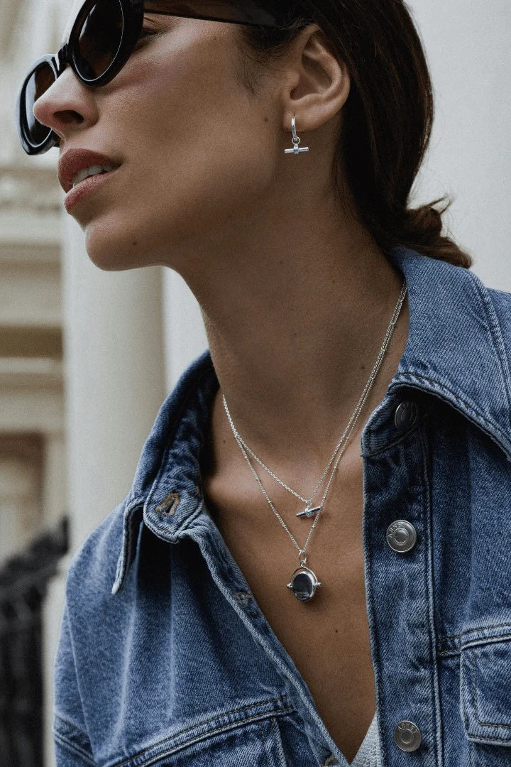 lady in dark glasses wearing silver earrings