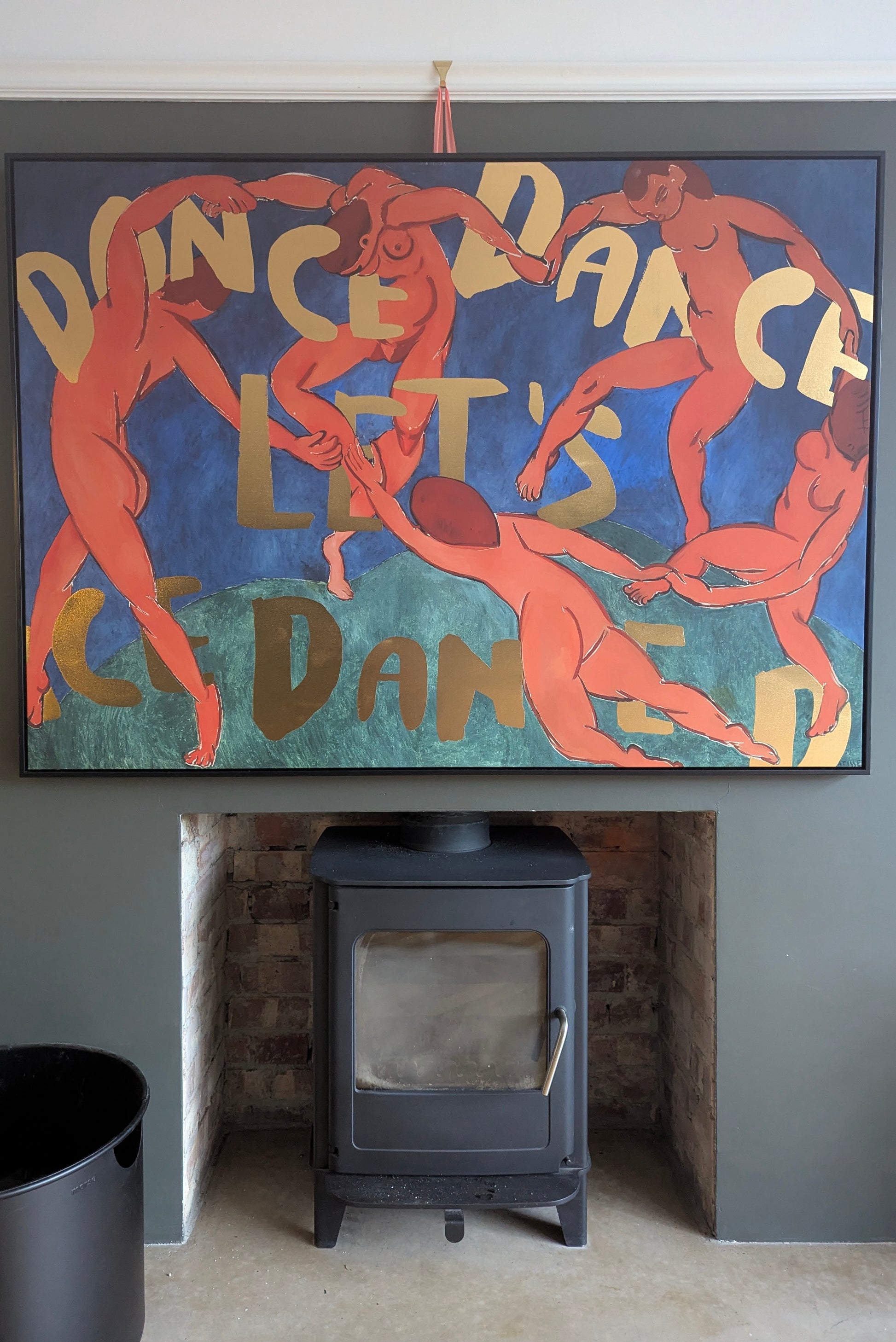 Framed artwork with dancers and the text 'Dance Dance Let's Dance' above a fireplace.