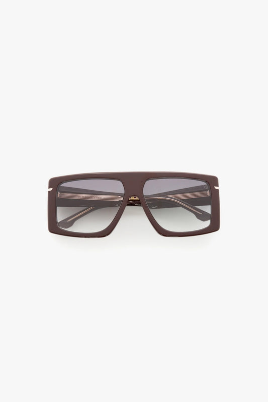 Sunglasses with a burgundy frame on a white background