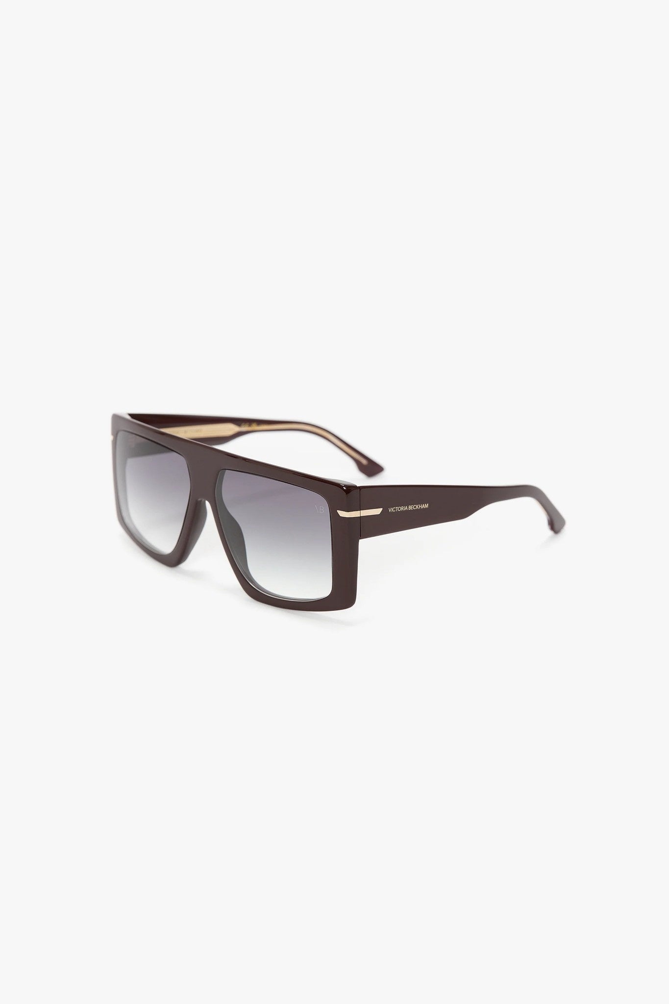 Sunglasses with a burgundy frame and gradient lenses on a white background