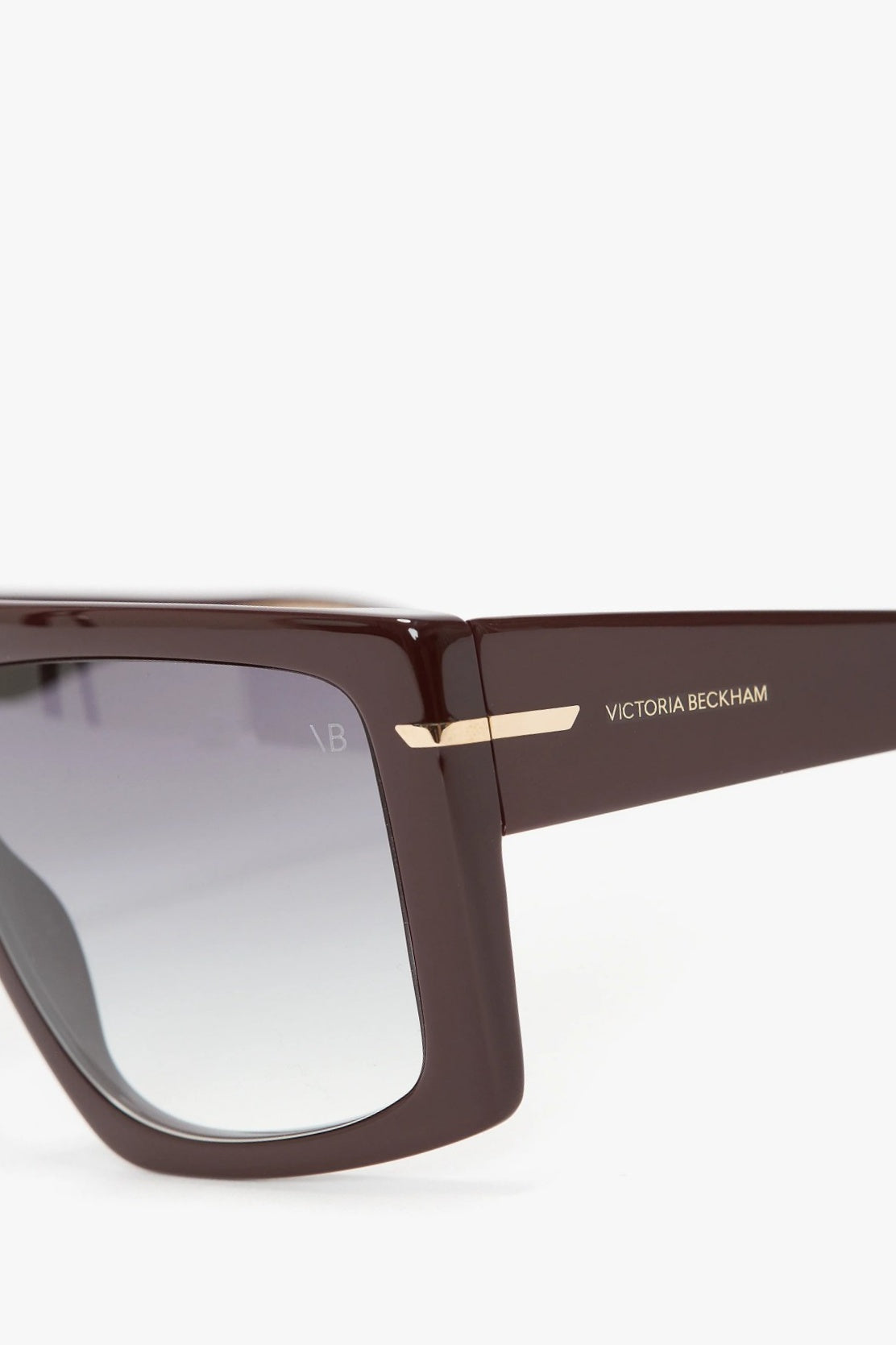 Brown sunglasses with 'Victoria Beckham' branding on a white background