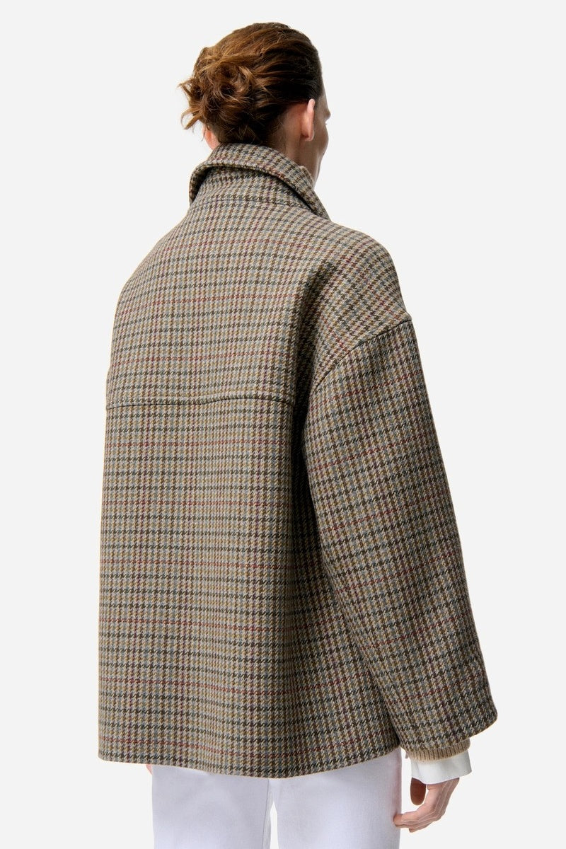 Model facing away wearing a checkered coat on a white background