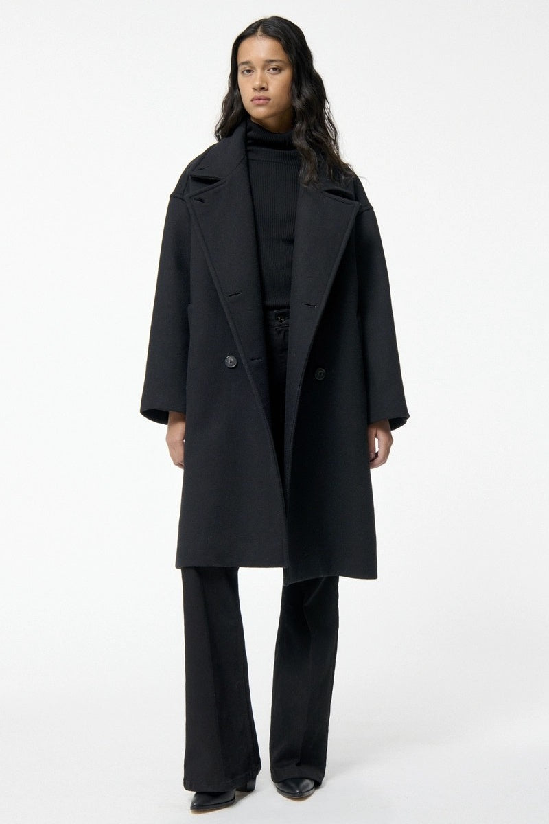 Person wearing a black coat on a white background