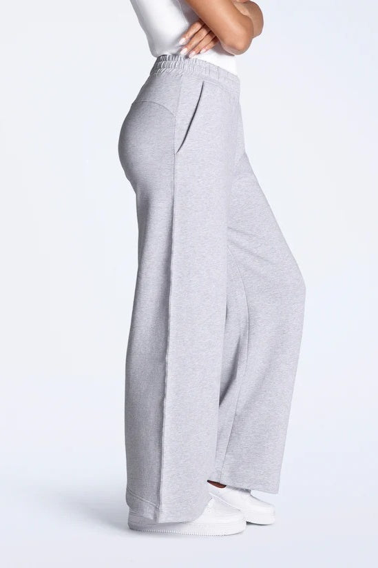 Gray wide-leg pants worn by a person on a white background