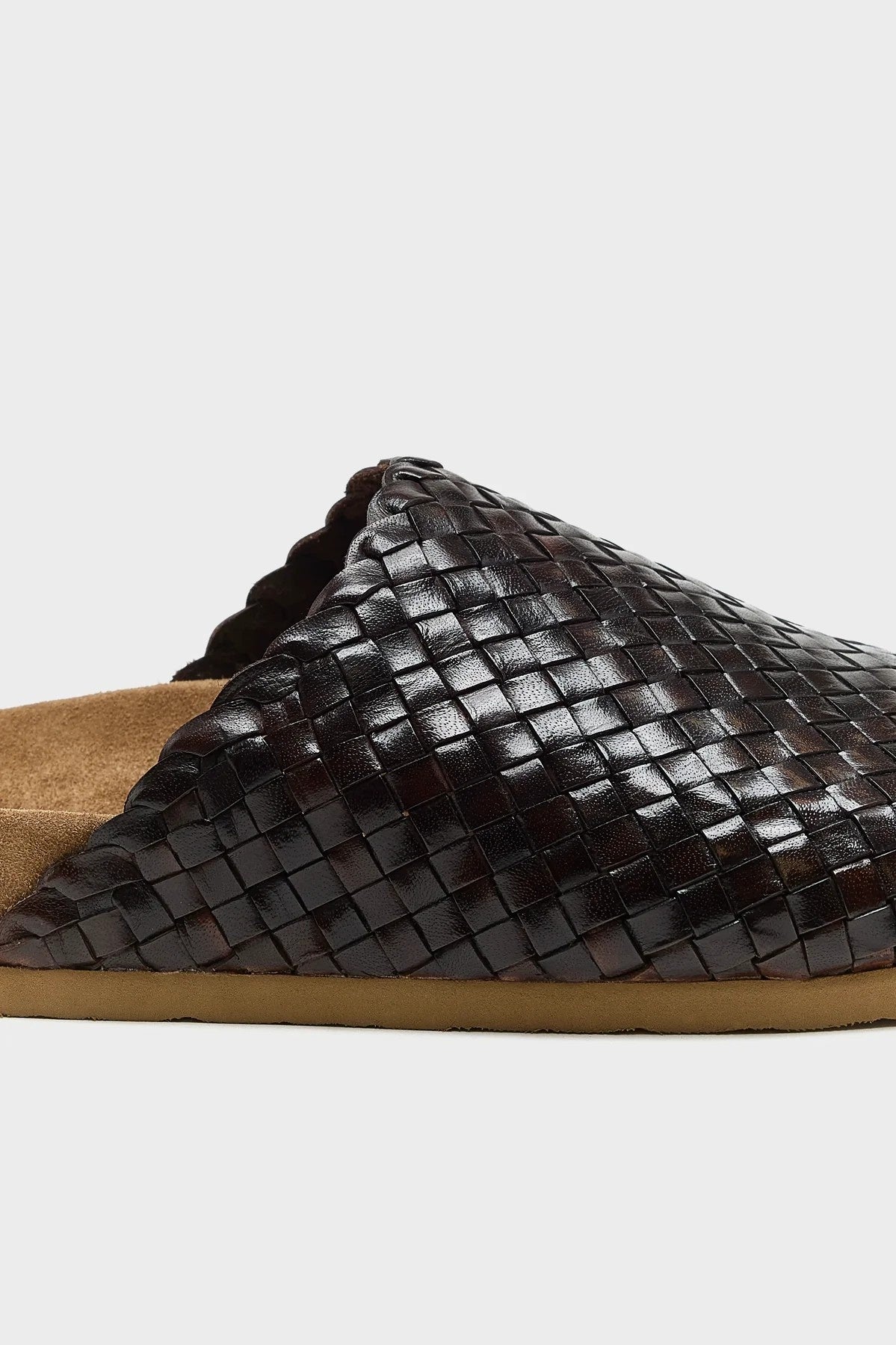 Brown woven slide sandal on a light gray background